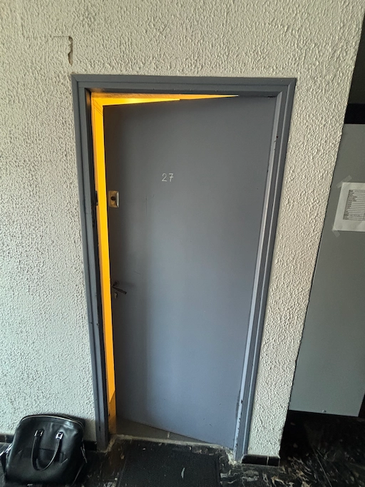 Porte grise entrouverte avec lumière intérieure